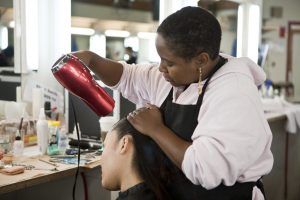 hairstylist doing the hair of one of her clients