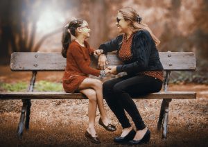 mom and daughter on a park bench 