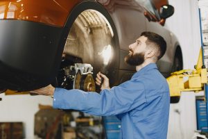 Mechanic servicing the brake pads on a car near Orangeburg, SC