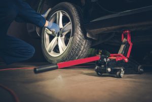 A mechanic performing a Kia tire rotation near Orangeburg, South Carolina.