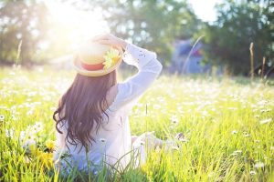 A person sitting in a field of grass and flowers near Orangeburg, South Carolina.