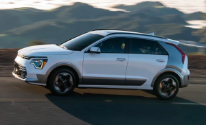 A white 2024 Kia Niro EV driving outdoors near Orangeburg, South Carolina.