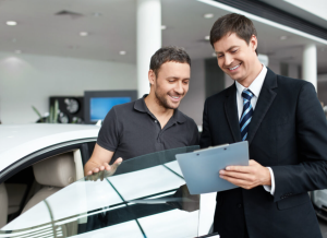 A Kia buyer talking to a sales agent about an extended warranty near Orangeburg, South Carolina.
