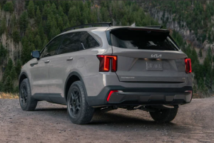 A 2024 Kia Sorento parked on a dirt road near a tree-covered hill near Orangeburg, SC