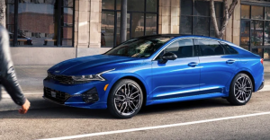 A person walking toward their parked blue Kia K5 near Orangeburg, South Carolina