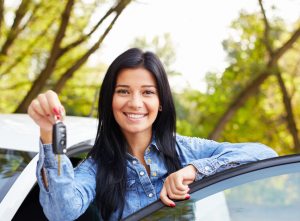 A person standing outside their car showing the key to their new car near Orangeburg, South Carolina