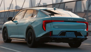 A photo of the rear end of a light blue 2025 Kia K4 driving on a bridge near Orangeburg, South Carolina