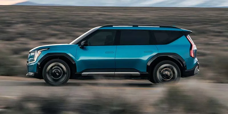 A 2026 Kia EV9 driving down a dirt road near Orangeburg, SC